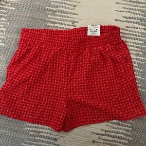 Never worn, coral and red patterned shorts.